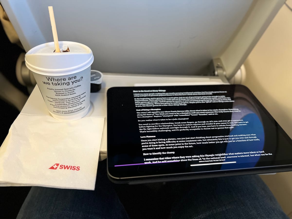 Picture of airplane tray with an iPad and a cup of terrible coffee